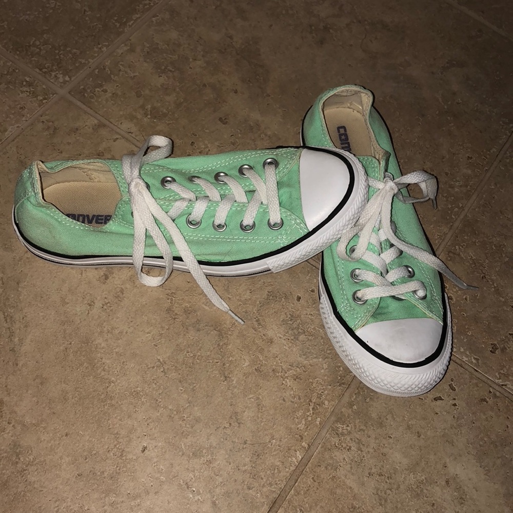Mint green low top converse.